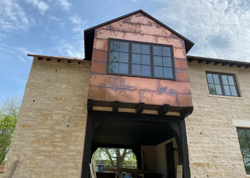 Copper metal panel facade on a stone building for Roof Repair in Lake Mathews