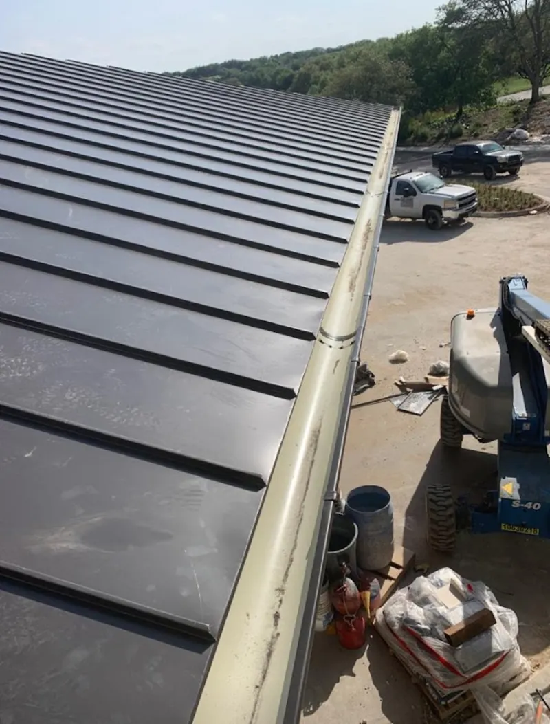 Standing seam panel and gutter detail on a metal roofing jobsite in Lake Mathews